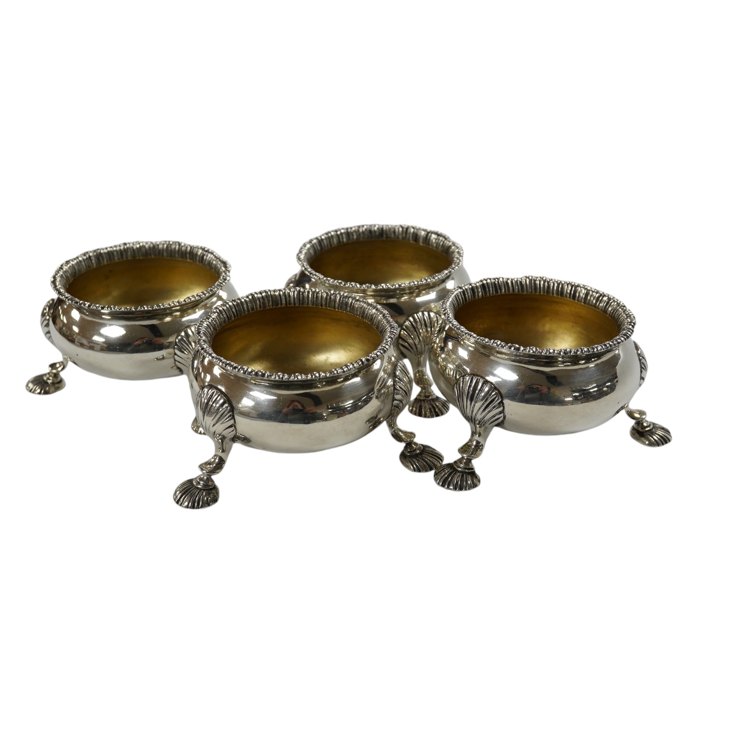 A set of four late William IV silver bun salts, on hoof feet, London, 1836, makers mark rubbed, diameter 72mm, 15.4oz. Condition - fair